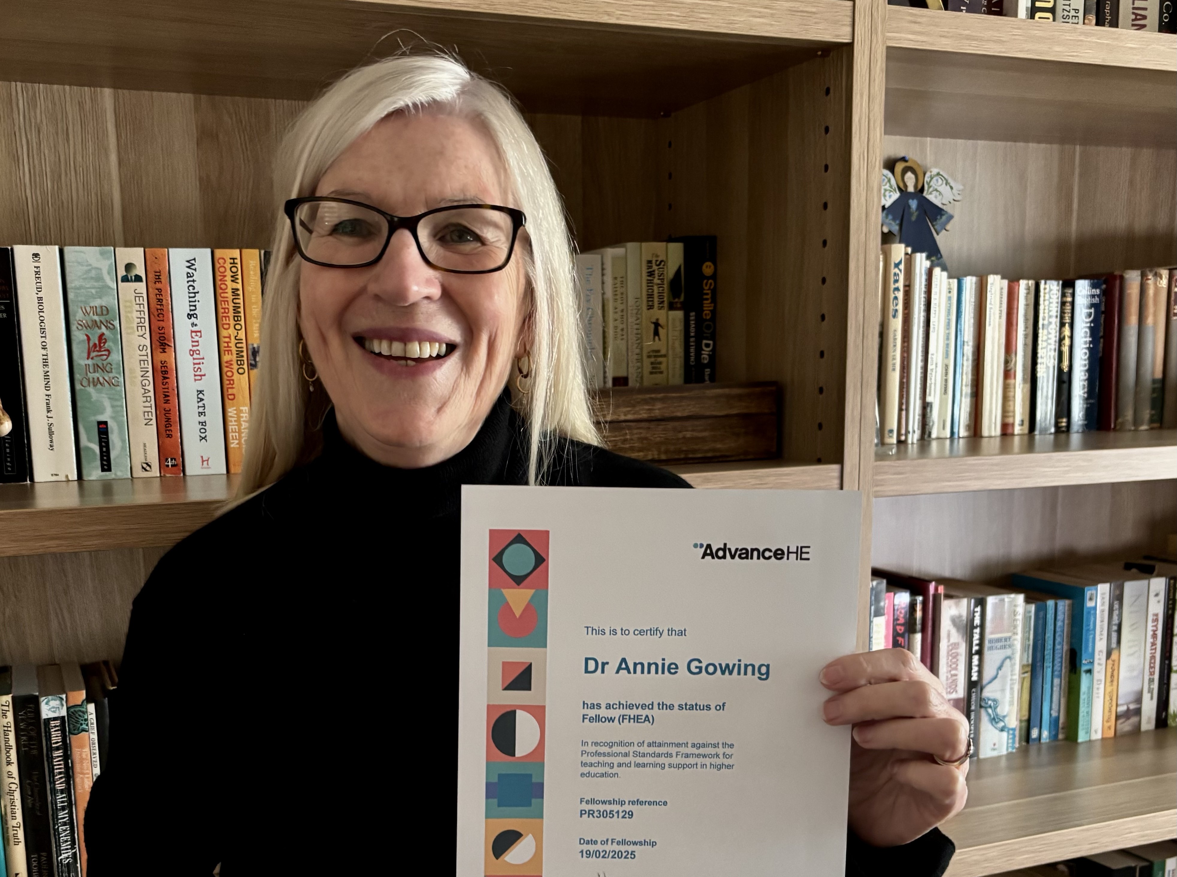 Image of Annie Gowing holding up her Advance HE Fellowship certificate