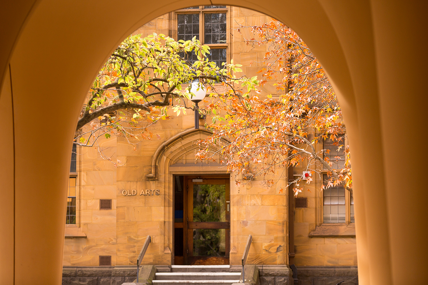 View of Old Arts entryway through an arch
