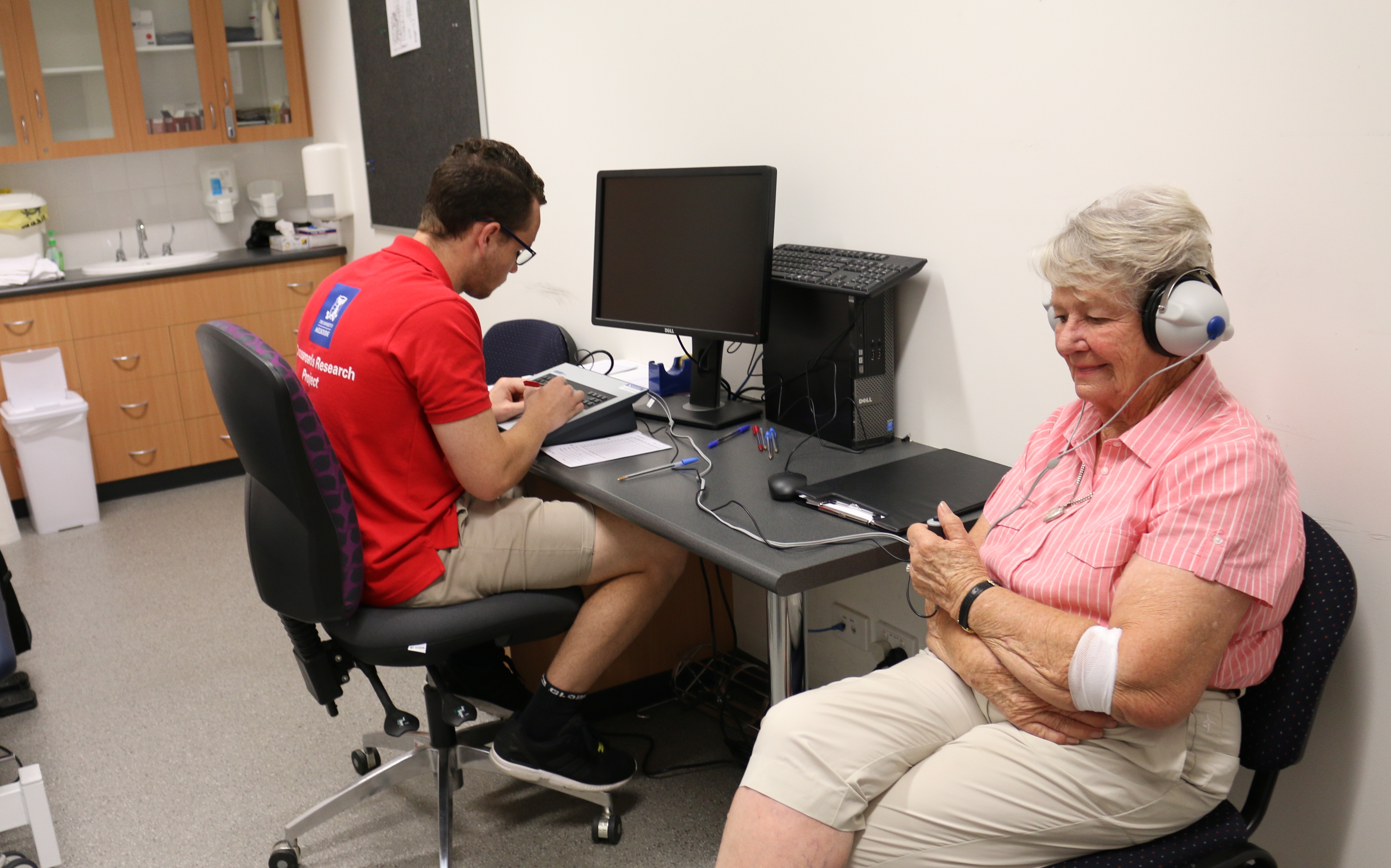 Elderly patient having their hearing checked by University of Melbourne researcher 