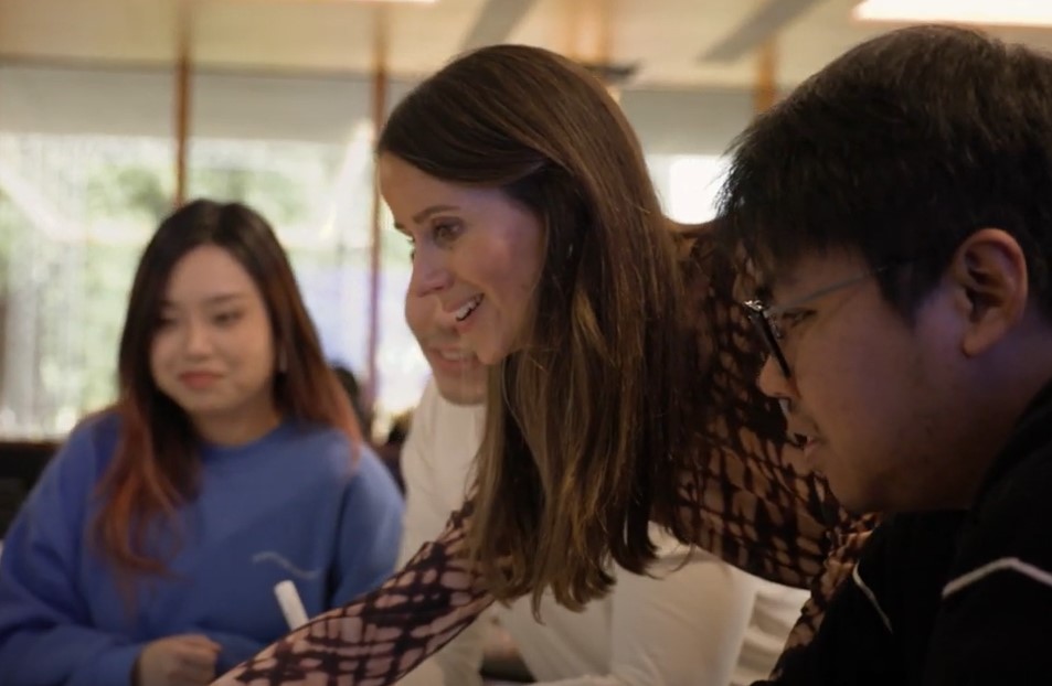 Image of Emma Power speaking with students 