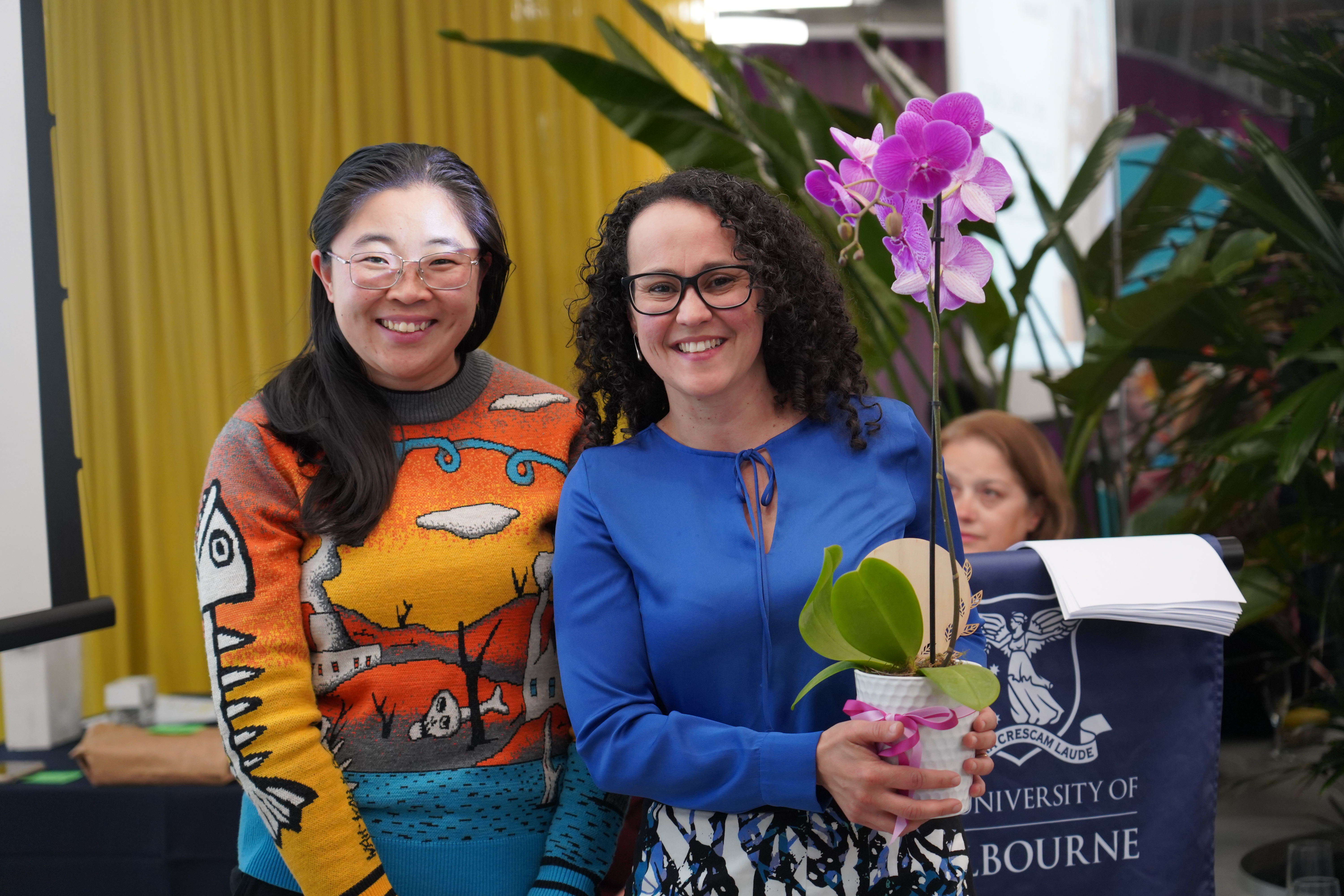 Director of the Wattle Fellowship Linh Do presenting the Excellence in Teaching, Learning and Research Award to Associate Professor Christhina Candido.