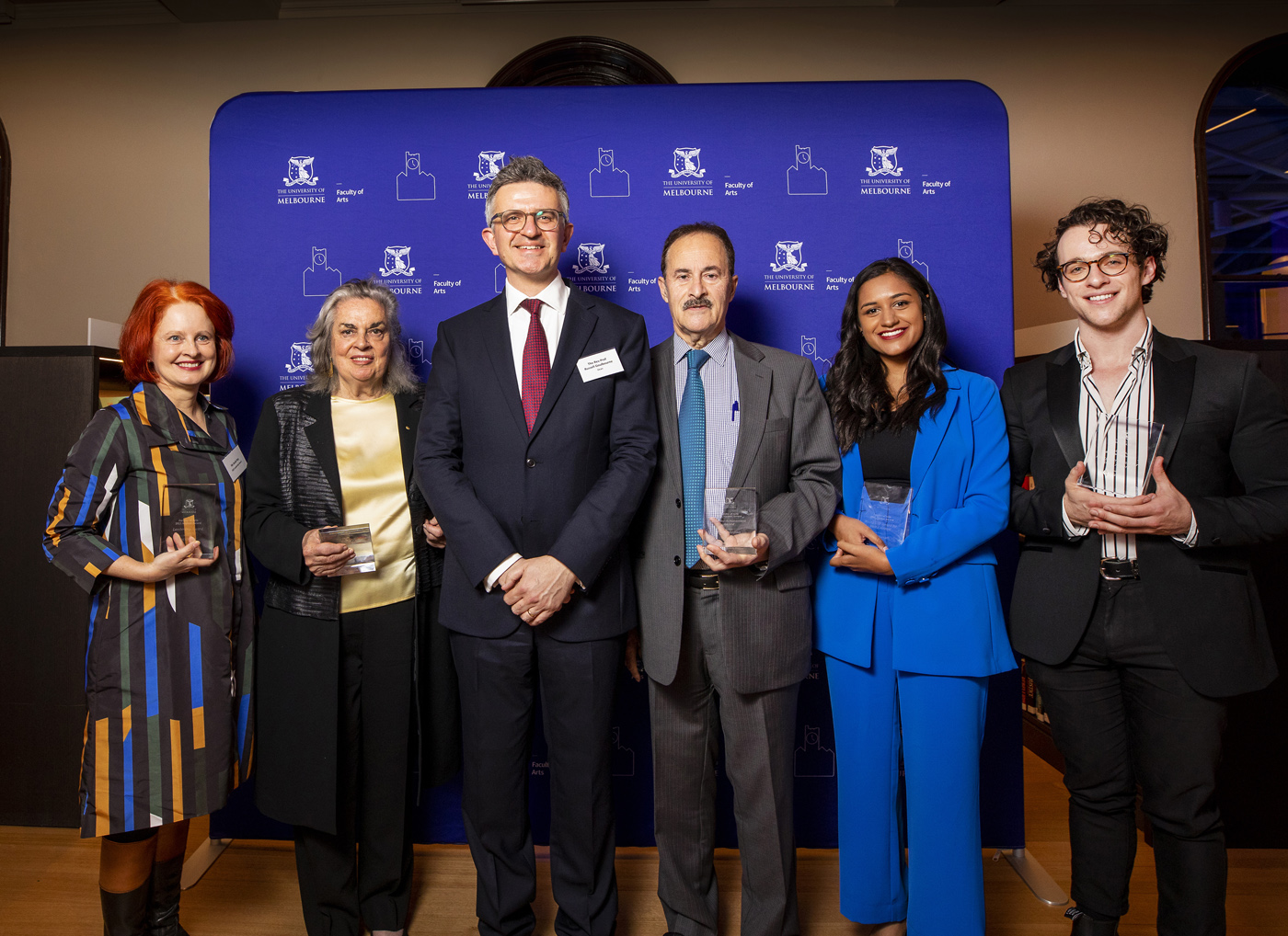 Recipients of the 2022 Arts Alumni Awards pose with their awards after the ceremony with Dean of the Faculty of Arts The Revd Professor Russell Goulbourne.