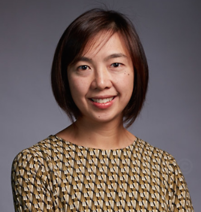 Headshot of A/Prof Ada Cheung standing in front of a grey background. 