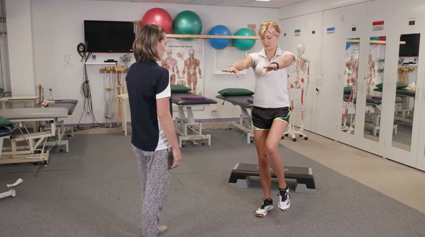 Sonya instructing a person to do a balance exercise